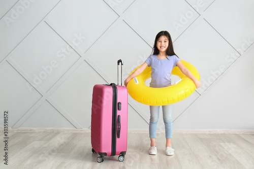 Cute girl with suitcase and...