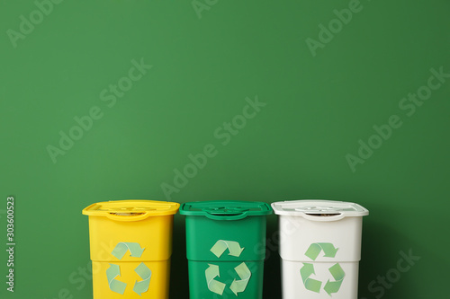 Containers for garbage near color wall. Recycling concept Fototapet
