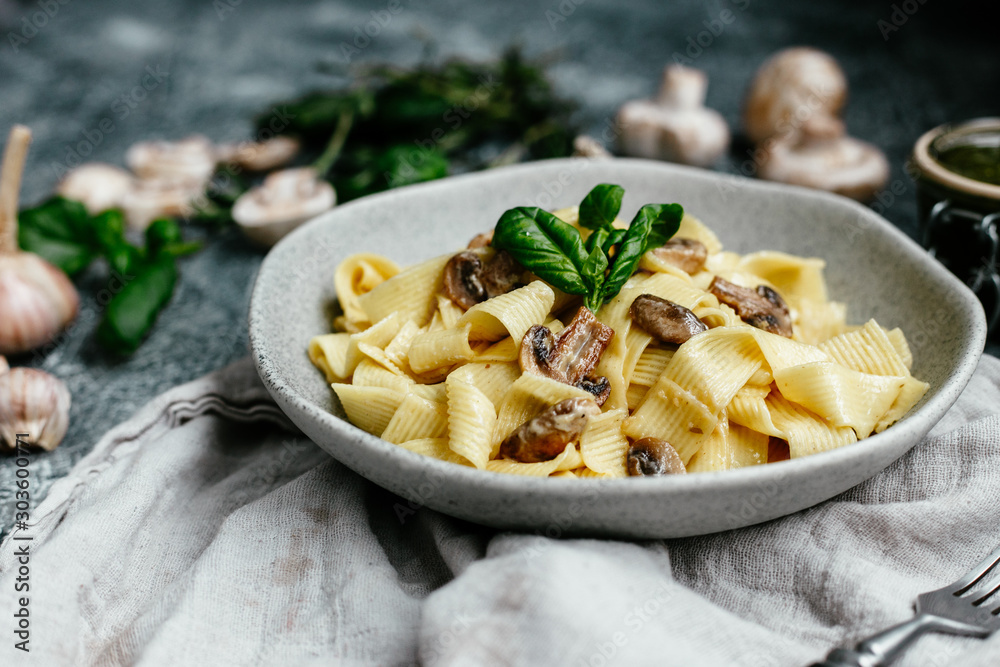 Plate with spaghetti with mushrooms in a creamy sauce on the table Plate with spaghetti with mushrooms in a creamy sauce on the table