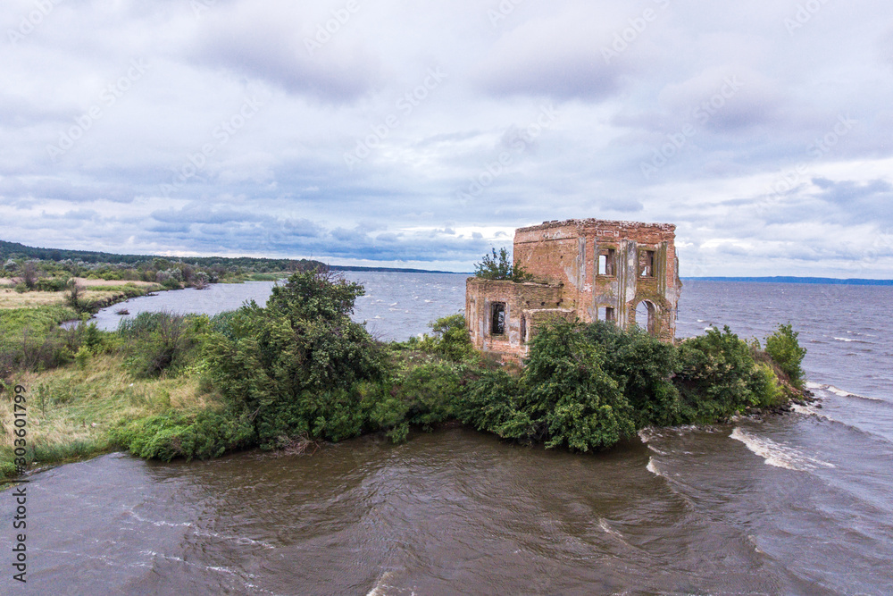 The ruins of the church of St. Elijah in the village of Tsybli, Ukraine. Church on river.  Waves and beautiful sky.