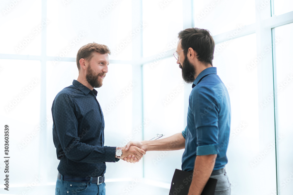 business people shaking hands in a bright office