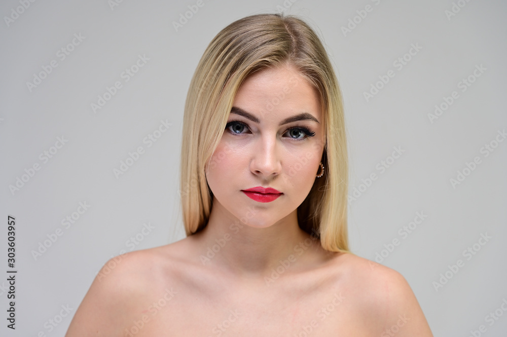 Concept cosmetically, skin rejuvenation. Close-up portrait of a beautiful blonde model on a white background with long hair, excellent makeup, beautiful face and lips. Concept cosmetically, skin rejuvenation. Close-up portrait of a beautiful blonde model on a white background with long hair, excellent makeup, beautiful face and lips.