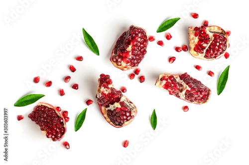 pomegranate slices and green leaves isolated on a white background, top view
