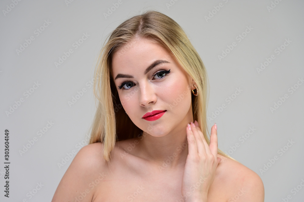 Concept cosmetically, skin rejuvenation. Close-up portrait of a beautiful blonde model on a white background with long hair, excellent makeup, beautiful face and lips. Concept cosmetically, skin rejuvenation. Close-up portrait of a beautiful blonde model on a white background with long hair, excellent makeup, beautiful face and lips.