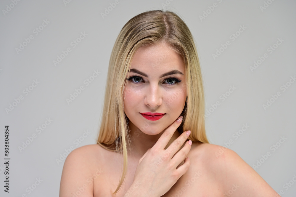 Concept cosmetically, skin rejuvenation. Close-up portrait of a beautiful blonde model on a white background with long hair, excellent makeup, beautiful face and lips. Concept cosmetically, skin rejuvenation. Close-up portrait of a beautiful blonde model on a white background with long hair, excellent makeup, beautiful face and lips.