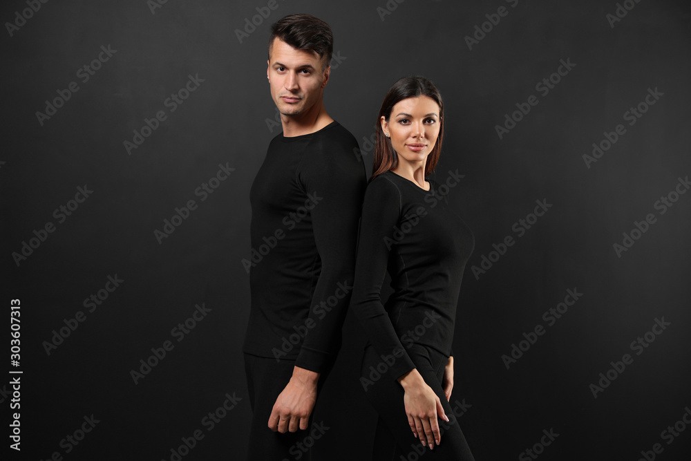 Couple wearing thermal underwear on black background Couple wearing thermal underwear on black background