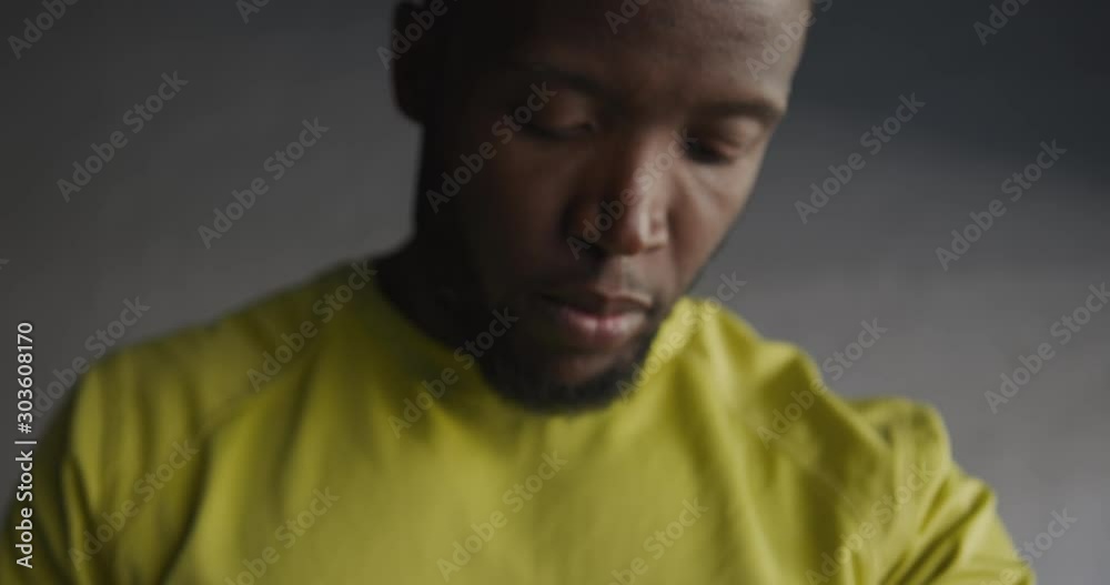 Man training in an urban checking smartwatch Man training in an urban checking smartwatch