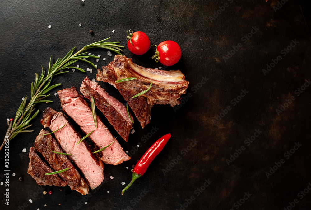Beef steak, herbs and spices on a stone background, top view - obrazy, fototapety, plakaty 