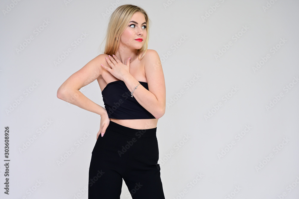 Glamorous cosmetics concept. Portrait of a fashionable beautiful blonde model on a white background with long hair, excellent makeup, beautiful face and lips on. Glamorous cosmetics concept. Portrait of a fashionable beautiful blonde model on a white background with long hair, excellent makeup, beautiful face and lips on.