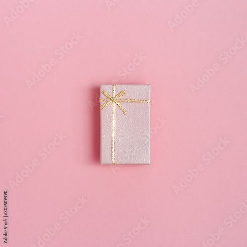 Pink gift box with surprise for woman holiday, 8 March, Valentines day, Womans Day. Pink paper romantic background, celebtate greeting card. photo