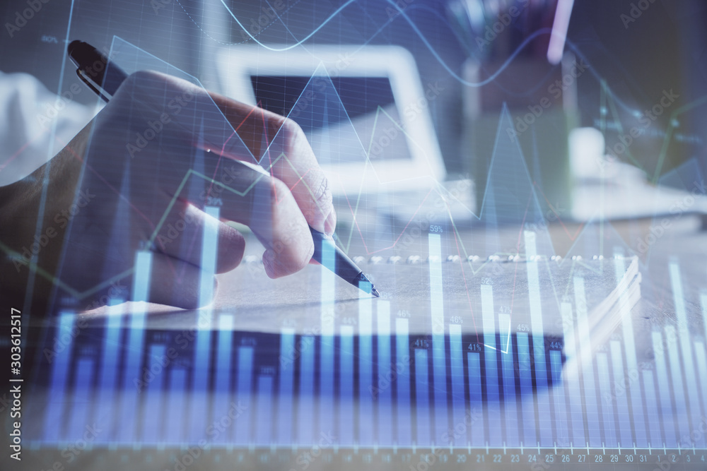 Financial charts displayed on woman's hand taking notes background. Concept of research. Double exposure Financial charts displayed on woman's hand taking notes background. Concept of research. Double exposure