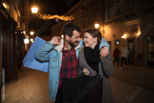 Close up of a young couple shopping in the city at night