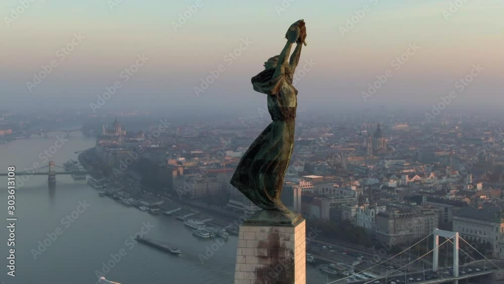 Budapest, Hungary, aerial view of Liberty Statue and Budapest cityscape at sunrise. Budapest, Hungary, aerial view of Liberty Statue and Budapest cityscape at sunrise.