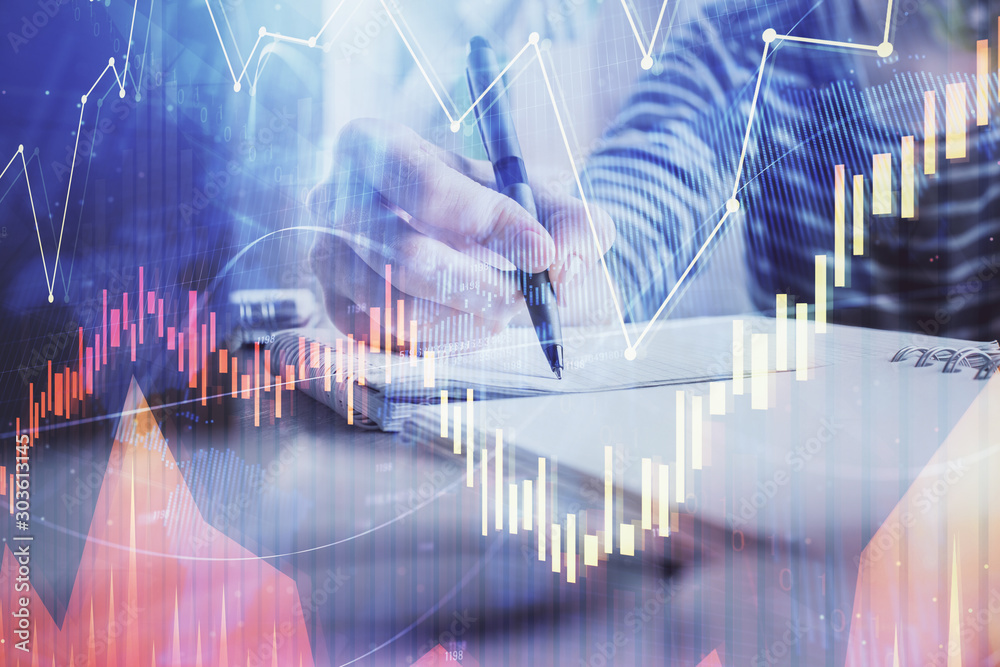 Financial forex graph drawn over hands taking notes background. Concept of research. Double exposure Financial forex graph drawn over hands taking notes background. Concept of research. Double exposure