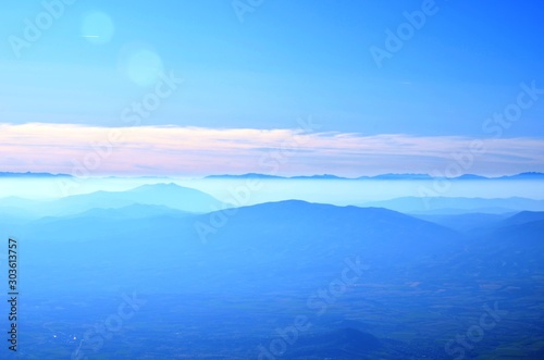 Pieria, Central Macedonia, Greece, 10/25/19. Mount Olympus landscape - blue mountains, pink fog, blue sky - on the road to Olympus on the West Side. National park of Greece photo