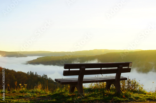 Bank im Abendlicht hoch über dem Herbstnebel im Moseltal