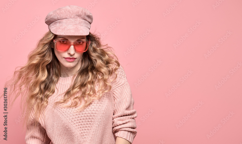 Fashionable lovable woman in Trendy pink outfit, stylish hairstyle, makeup smiling. Young blonde in jumper. Sensual beautiful model girl in stylish sunglasses, pastel fashion beauty on pink, banner Fashionable lovable woman in Trendy pink outfit, stylish hairstyle, makeup smiling. Young blonde in jumper. Sensual beautiful model girl in stylish sunglasses, pastel fashion beauty on pink, banner