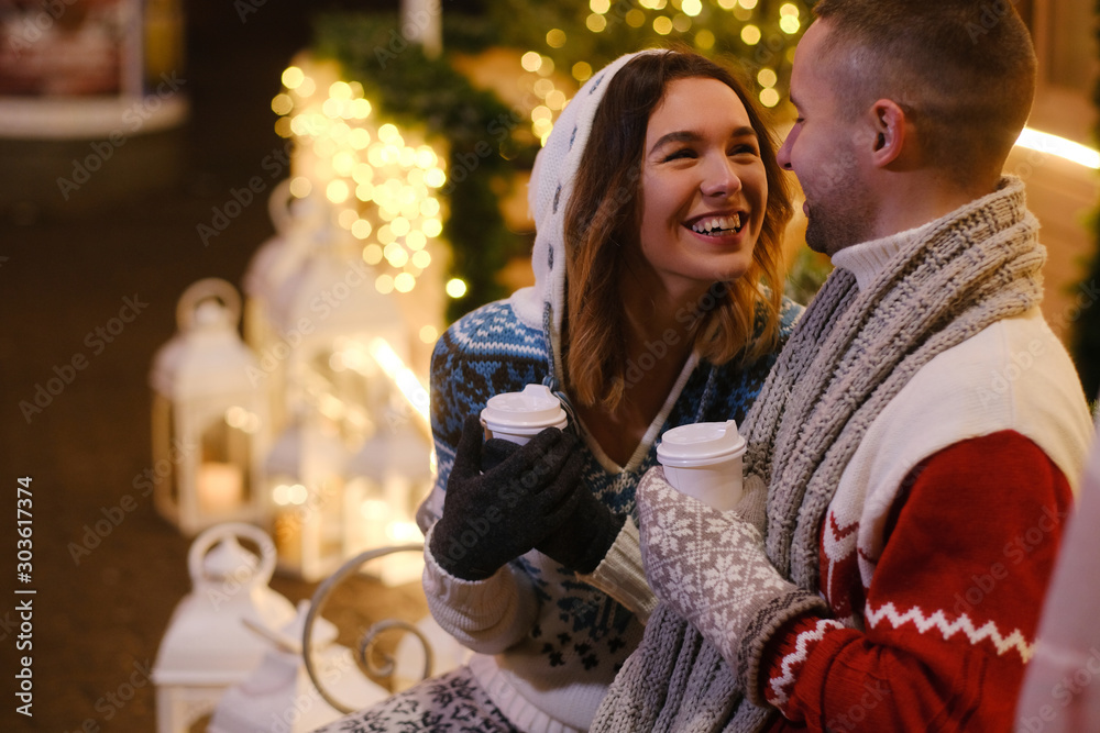 Φωτογραφία Pretty woman feels happy with her man enjoying hot drink on the Christmas Eve
