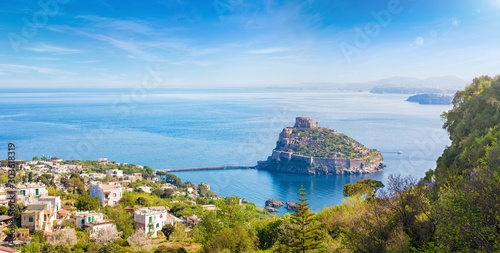 Aerial panoramic view of Aragonese Castle, most popular landmark and travel destination located in Tyrrhenian sea near Ischia island, Italy.