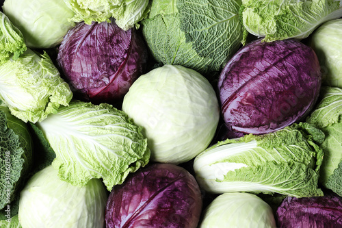 Valokuva Different types of cabbage as background, top view