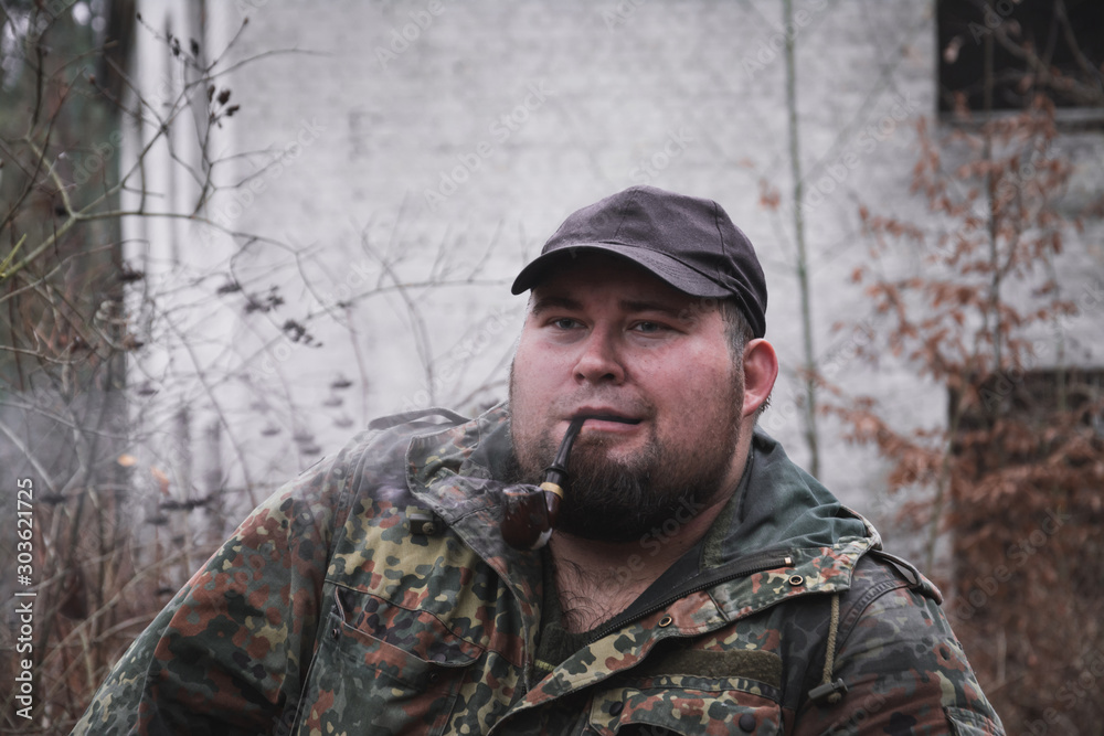 Russian forester smokes tobacco through a pipe