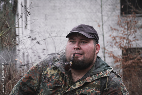 Russian forester smokes tobacco through a pipe
