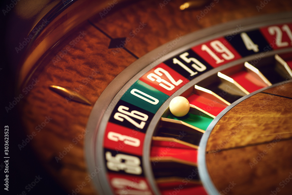 Roulette wheel with a white ball on green at zero number in a casino Roulette wheel with a white ball on green at zero number in a casino