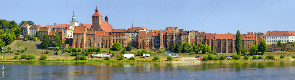 Panorama of historic granaries in Grudziadz at the Vistula River in northern Poland. Situated in the Kuyavian-Pomeranian Voivodeship - obrazy, fototapety, plakaty 