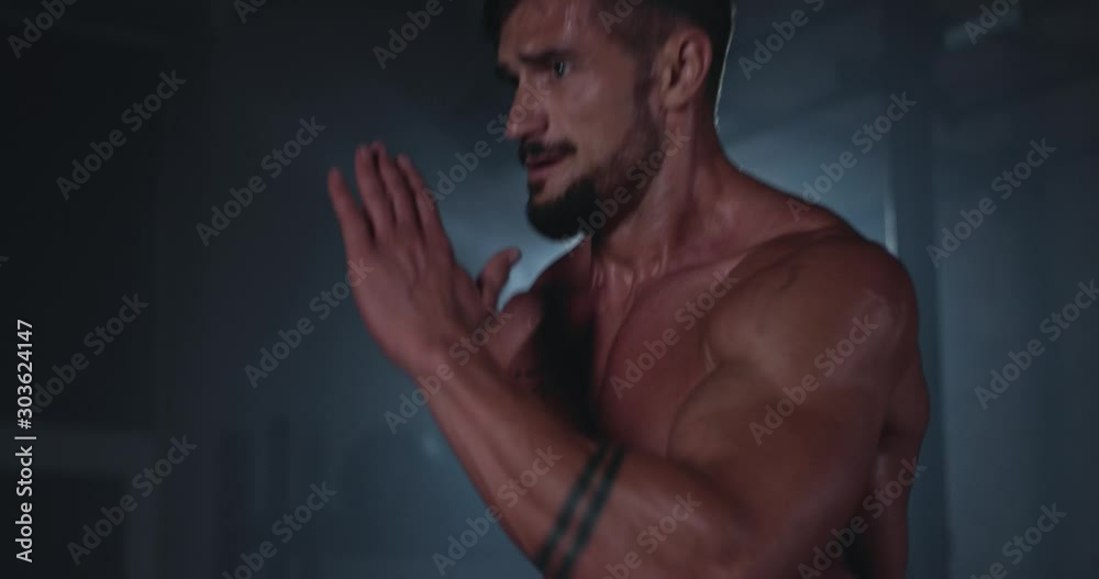 Concept of a cross fitness class running athletic man in a gym class get sweating very hard while doing his hard workout training Concept of a cross fitness class running athletic man in a gym class get sweating very hard while doing his hard workout training
