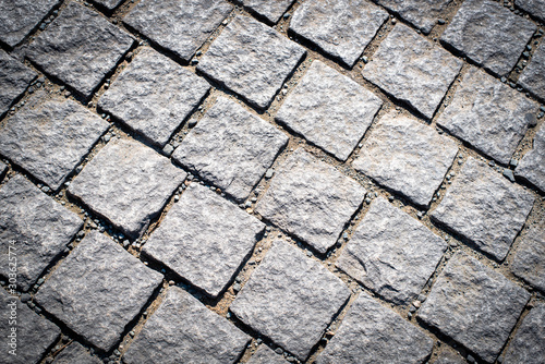 Pedestrian brick stones in a row creating a pattern background.
