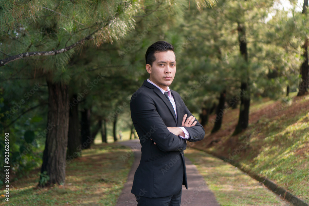Young Asian Malay Man at the park wearing suit Young Asian Malay Man at the park wearing suit