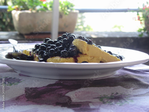 Italian molded zabaione ice cream or gelato called spumone with fresh bilberries or european blueberries photo