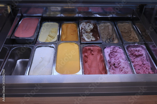 Assorted ice cream flavors in metal tubs