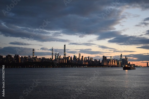 Little Boat, Big City Skyline at Sunset