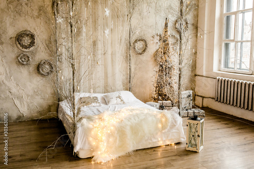 New Year design interior of beautiful bedroom in gray tones. Traditional winter holidays Christmas / New Year.