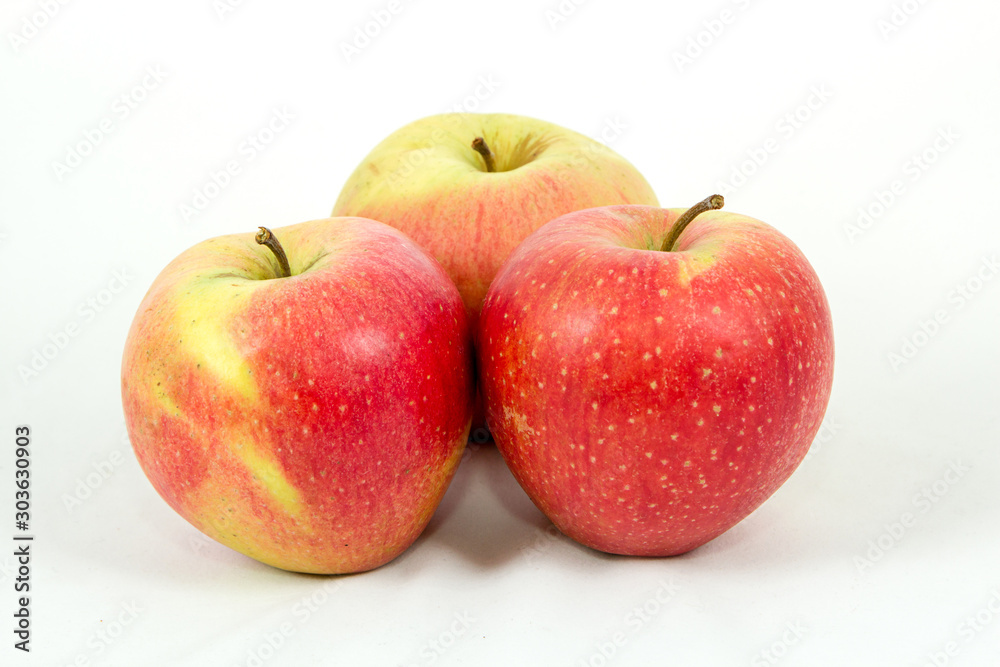 triangle of three large red apples on a white background