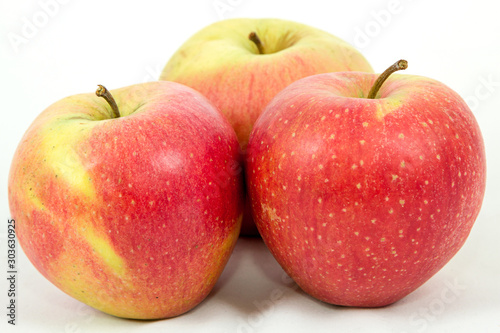 triangle of three large red apples on a white background