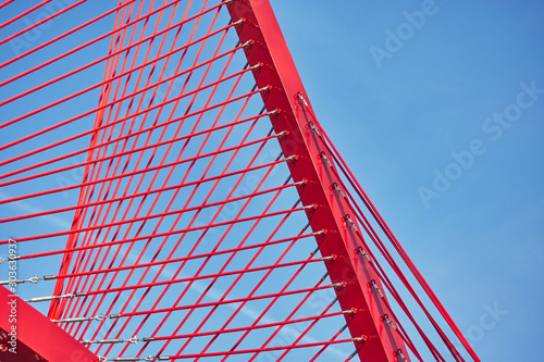 Abstract architectural features, steel beam with cables on sky background