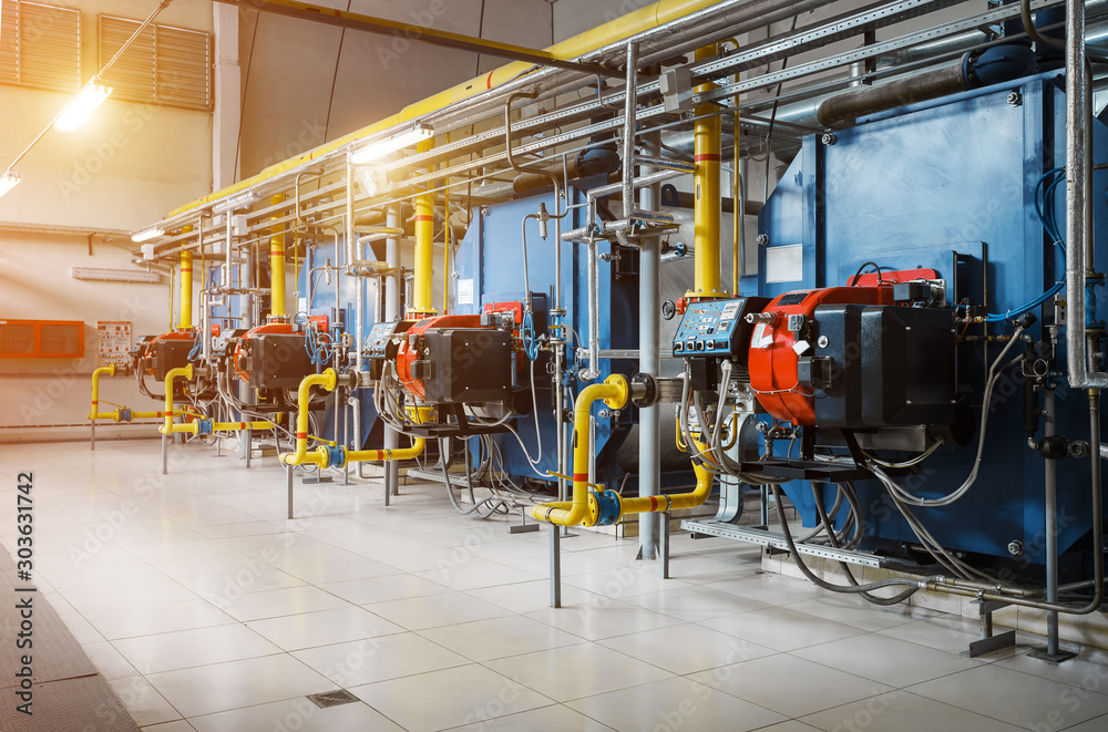 Modern industrial gas boiler room equiped for heating process. Heating gas  boilers in a row, pipelines, valves. Stock Photo | Adobe Stock