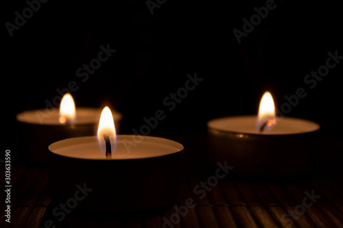 three candles in the dark with copy space