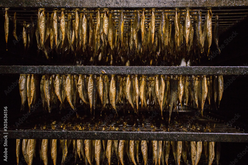 Golden smoked sprats in the factory
