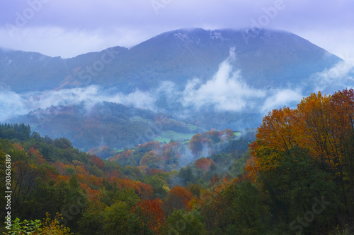 clouds and mists in bad weather in autumn in the forests of the Araxes valley with Mount Elosta, Navarra