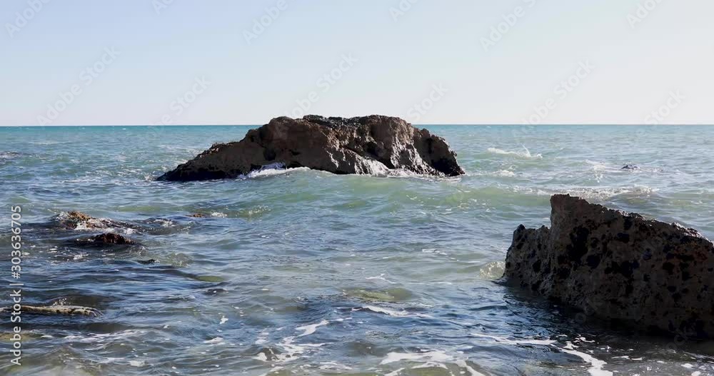 Views in a sunny day of the Mediterranean Sea shore in the coastline near Málaga, Spain Views in a sunny day of the Mediterranean Sea shore in the coastline near Málaga, Spain