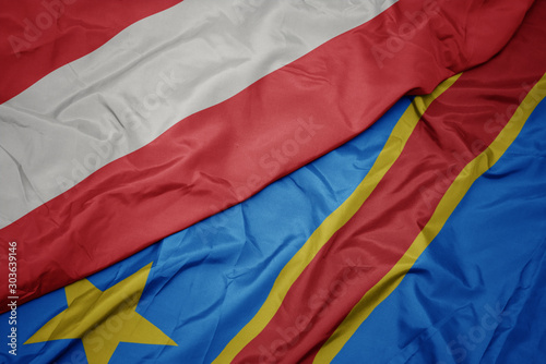 waving colorful flag of democratic republic of the congo and national flag of austria.