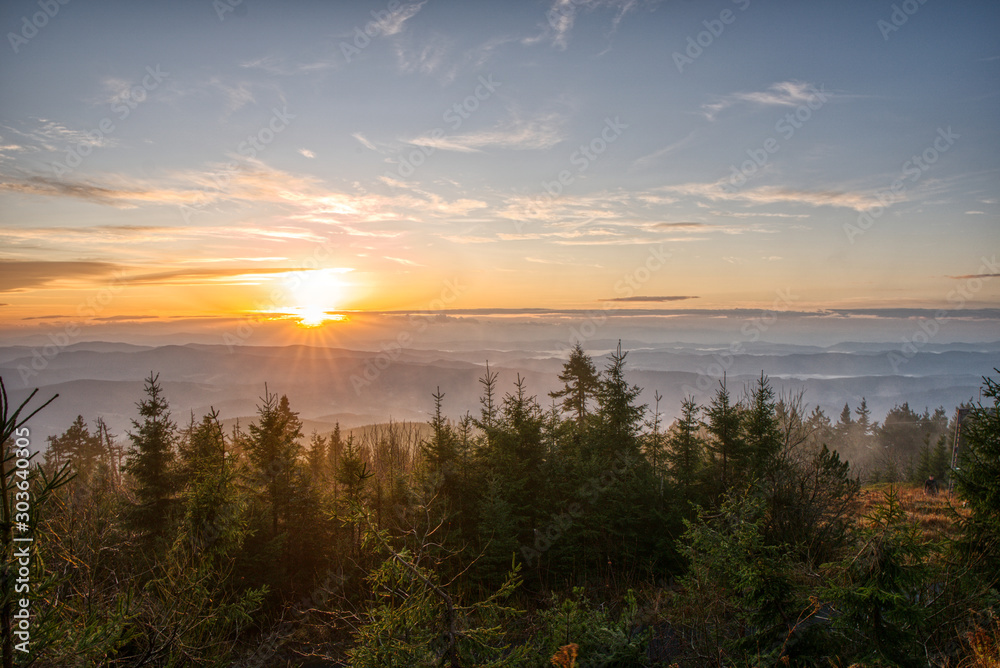 Gorgeous sunrise with fog in the mountains with trees in the foreground, Czech, Lysa Mountain Gorgeous sunrise with fog in the mountains with trees in the foreground, Czech, Lysa Mountain