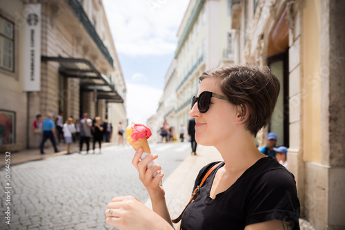 A woman eats gelato in Lisbon photo