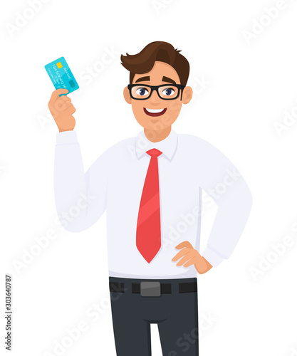 Young business man in formal wear with red colour tie holding or showing a credit (Debit, ATM) card. Male character design illustration. Modern lifestyle concept in vector cartoon style.
