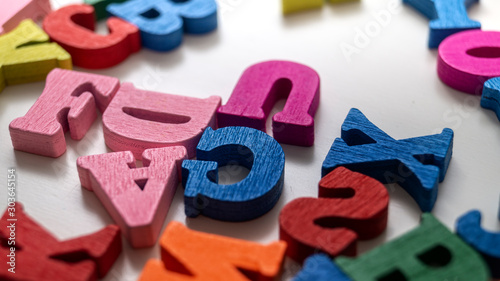Colorful wooden letters on wooden background