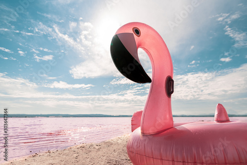 inflatable pink pelican mattress on pink sea photo