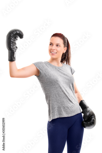 Girl with boxing gloves raising hand in celebration